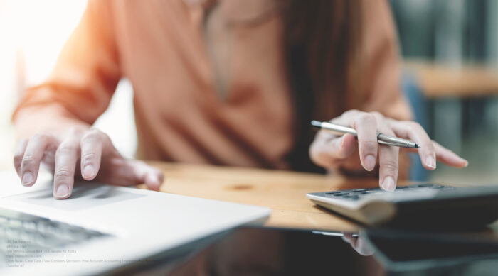 Asian Female Accountant Or Banker Making Calculations. Savings,